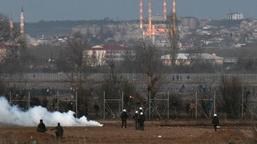 Greek riot police officers stand guard next to tear gas, as migrants are seen on the other side of the border fence, near Greece’s Kastanies border crossing with Turkey’s Pazarkule, Greece March 7, 2020. (Reuters)