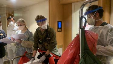 Medical personnel don full personal protective equipment as they prepare to test travelers on the Grand Princess cruise ship for the coronavirus currently off the coast of California, US, March 5, 2020. (Reuters)