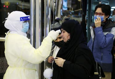 Passengers coming from China wearing masks to prevent coronavirus infection are checked by Saudi Health Ministry employees upon their arrival at King Khalid International Airport, in Riyadh, Saudi Arabia, January 29, 2020. (Reuters)