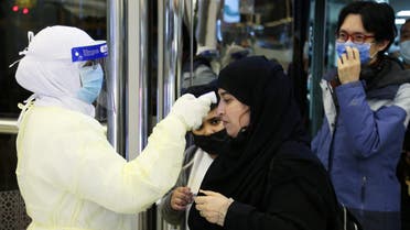 Passengers coming from China wearing masks to prevent coronavirus infection are checked by Saudi Health Ministry employees upon their arrival at King Khalid International Airport, in Riyadh, Saudi Arabia, January 29, 2020. (Reuters)