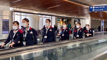 Japanese airline (JAL) crew are seen at Los Angeles International Airport (LAX) wearing masks, to prevent the coronavirus infection, on February 12, 2020. (AFP)
