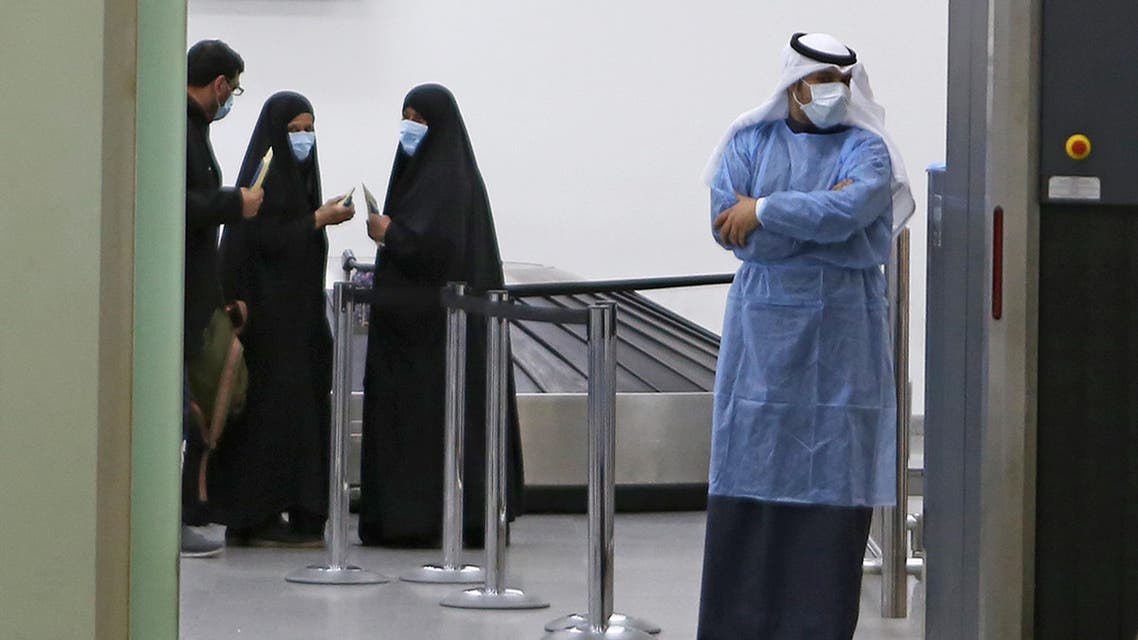 Kuwaitis coming back from Iran wait at Sheikh Saad Airport in Kuwait City, on February 22, 2020, before being taken to a hospital to be tested for coronavirus. (AP)