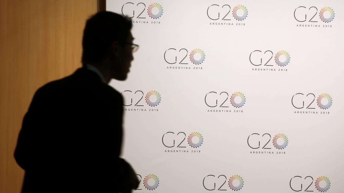 A man stands next to a board with the G20 Meeting of Finance Ministers logo in Buenos Aires, Argentina. (File photo: Reuters)