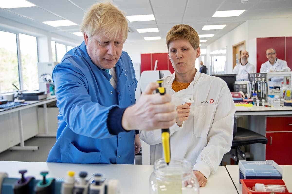Britain's Prime Minister Boris Johnson (1st-L) visits to the Mologic Laboratory in the Bedford technology Park, north of London on March 6, 2020. (AFP)
