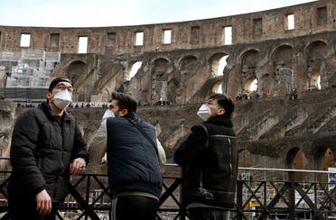 Tourists wearing respiratory masks visit the Coliseum in Rome on March 6, 2020. (AFP)