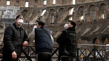 Tourists wearing respiratory masks visit the Coliseum in Rome on March 6, 2020. (AFP)