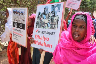 Somali women chant slogans and hold placards as they protest against Somali Islamist group al-Shabaab in Mogadishu on January 2, 2020. (AFP)