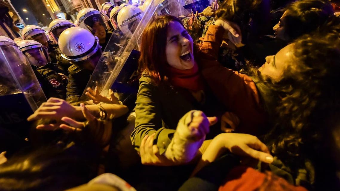 Turkish anti-riot police officers push back women during a rally marking International Women’s Day on Istiklal avenue in Istanbul on March 8, 2020. (AFP)