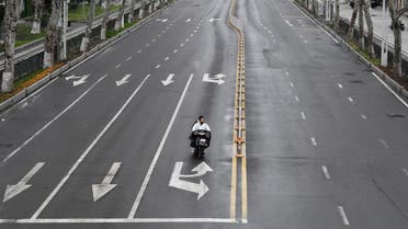 People ride an electric bike on a road in Wuhan, the epicentre of the novel coronavirus outbreak, Hubei province, China March 3, 2020. REUTERS/Stringer CHINA OUT.