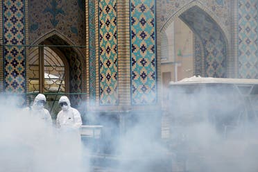 Members of the medical team spray disinfectant to sanitize outdoor place of Imam Reza's holy shrine, following the coronavirus outbreak, in Mashhad, Iran February 27, 2020. (Reuters)