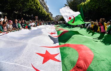 A file photo shows Algerian protesters march with a giant national flag during a demonstration in the capital Algiers on May 31, 2019. (AFP)