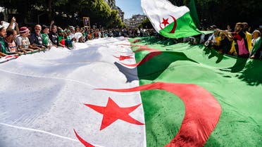 Algerian protesters march with a giant national flag during a demonstration in the capital Algiers on May 31, 2019. (AFP)
