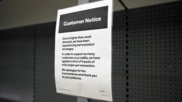 A notice placed next to empty shelves after customers stocked up on toilet paper amid coronavirus fears, is seen in a grocery store in Sydney, Australia, March 6, 2020. (Reuters)