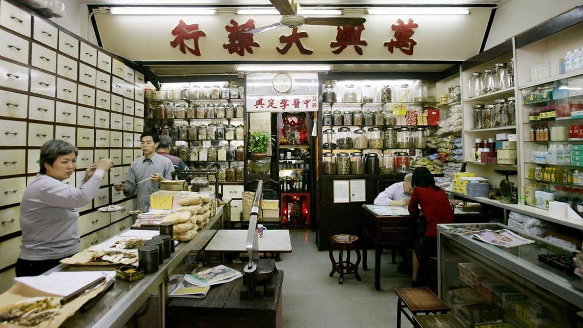 Workers mix herbs to make medicines in a Chinese medicine store and clinic. (File photo: AP)