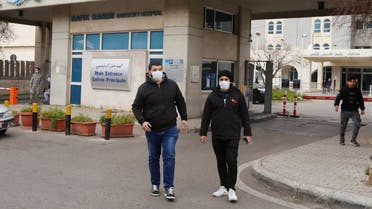 People wearing face masks walk outside Rafik Hariri hospital, where Lebanon's first coronavirus case is being quarantined, in Beirut, Lebanon February 21, 2020. (Reuters)