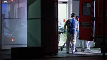 Medical staff in carry the first person infected with the coronavirus in the German state of North Rhine Westphalia out of an ambulance into the Liver and Infection Center of the University Hospital in Duesseldorf, Germany, Wednesday, Feb 26, 2020. (AP)
