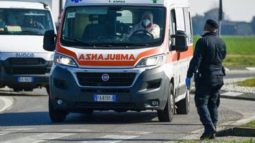 An ambulance drives past a police check-point few kilometers from the small town of Castiglione d'Adda, southeast of Milan, on February 24, 2020. (AFP)