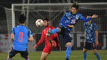 Japan's Yamaguchi Hotaru, right, fights for the ball with Kyrgyzstan's player during the World Cup 2022 Qualifying Asian zone Group F soccer match in Bishkek, Kyrgyzstan on Nov. 14, 2019. (AP)