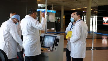 Medical staff wear protective gear before checking passengers with thermal scanners for coronavirus symptoms, at Queen Alia International Airport in Amman, Jordan, March 4, 2020. (Reuters)