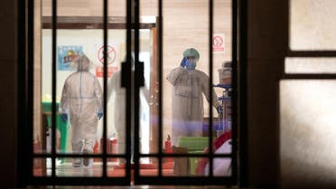 Medical staff in protective suits are seen inside a makeshift hospital that is closed following its last group of patients of the novel coronavirus have been discharged, in Wuhan, the epicentre of the novel coronavirus outbreak, in Hubei province, China March 1, 2020. (Reuters)