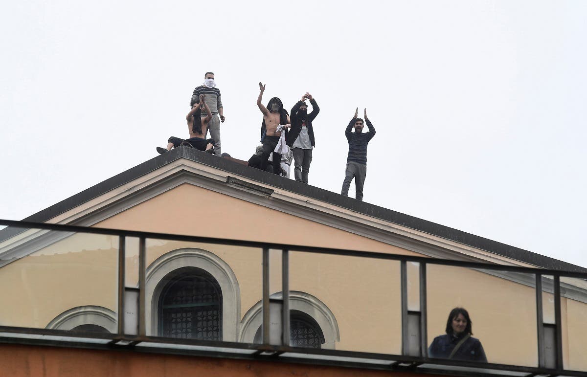 Inmates are seen on the roof of the San Vittore Prison during a revolt after family visits were suspended due to fears over coronavirus contagion, in Milan, Italy March 9, 2020. (Reuters)