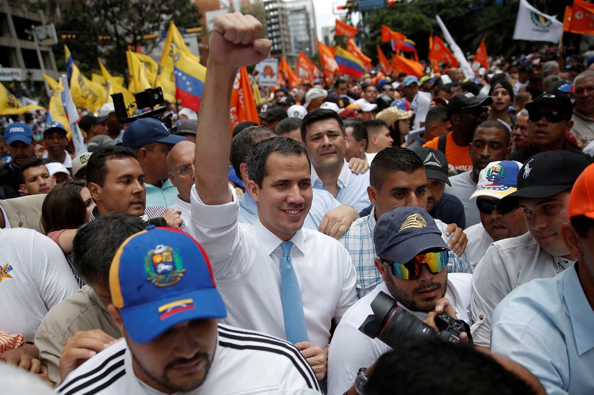 Venezuela’s National Assembly President and opposition leader Juan Guaido rises an arm as he takes part in a demonstration in Caracas, Venezuela March 10, 2020. (Reuters)