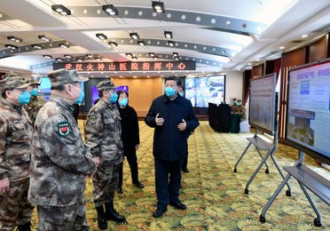 Chinese President Xi Jinping, right, is briefed about the Huoshenshan Hospital in Wuhan in central China's Hubei Province, on Tuesday, March 10, 2020. (AFP)