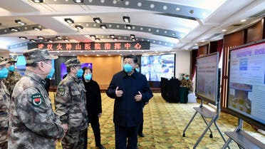 Chinese President Xi Jinping, right, is briefed about the Huoshenshan Hospital in Wuhan in central China's Hubei Province, on Tuesday, March 10, 2020. (AFP)