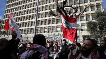 Anti-government protesters chant slogans, during ongoing protests against the Lebanese government in front of the Central Bank in Beirut on Feb. 1, 2020. (AP)