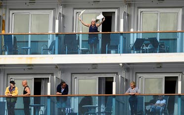 A passenger waves aboard the Grand Princess off the coast of San Francisco as a media boat approaches on Sunday, March 8, 2020. (AP)