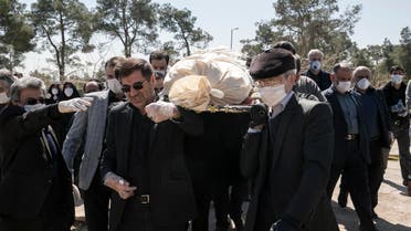 Mourners wearing face masks and gloves carry the body of former politburo official in the Revolutionary Guard Farzad Tazari, who died Monday after being infected with the new coronavirus, at the Behesht-e-Zahra cemetery just outside Tehran, Iran, on Tuesday, March 10, 2020. (AP) 