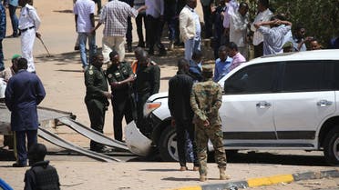 Security forces gather next to a damaged vehicle at the site of an assassination attempt against Sudan's Prime Minister Abdalla Hamdok, who survived the attack with explosives unharmed, in the capital Khartoum on March 9, 2020. (AFP)