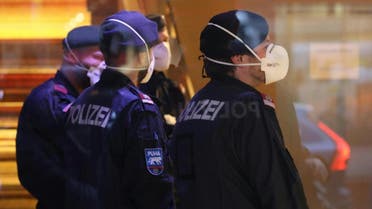 Police officers wear protective masks as they close a hotel near the city centre in Innsbruck, Austria, on February 25, 2020 after a woman who worked here has been confirmed infected with the coronavirus. (AFP)
