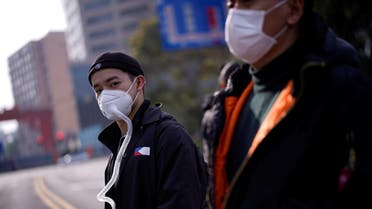 People wearing protective face masks are seen on a crossroads as the country is hit by an outbreak of the coronavirus, in Shanghai, China, March 10, 2020. (Reuters)