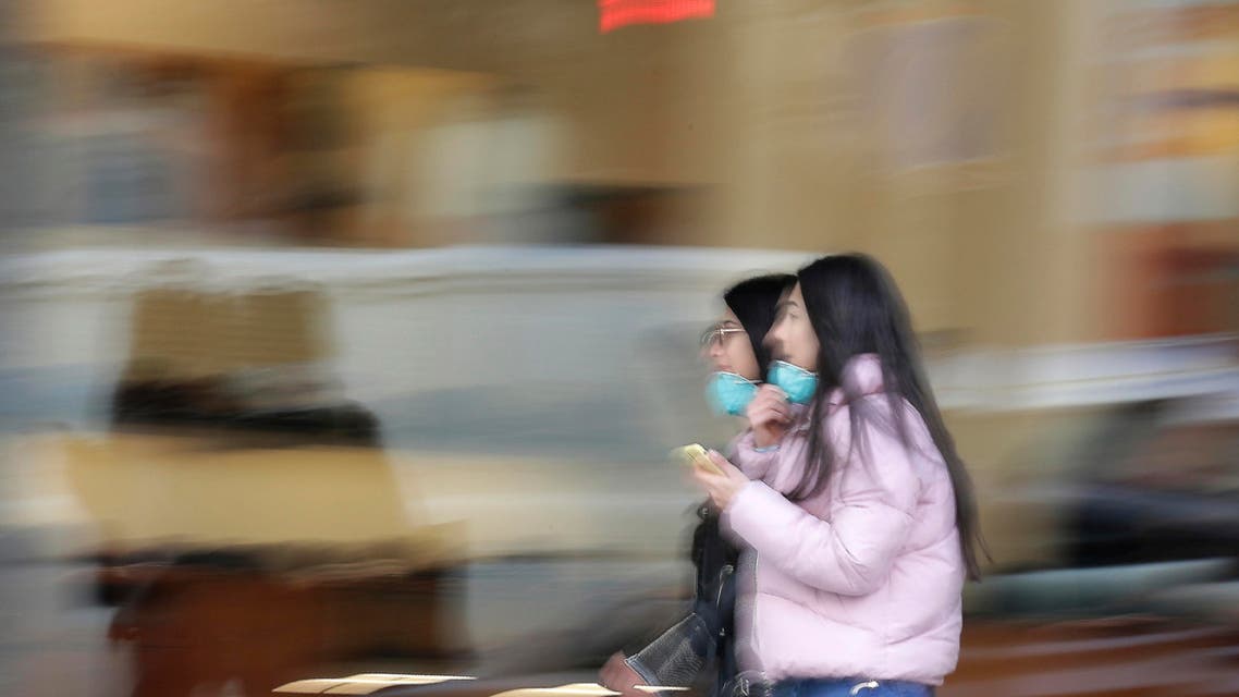 People wear masks to help protect themselves from the new coronavirus on Hamra street in Beirut, Lebanon, Wednesday, March 11, 2020. (AP)