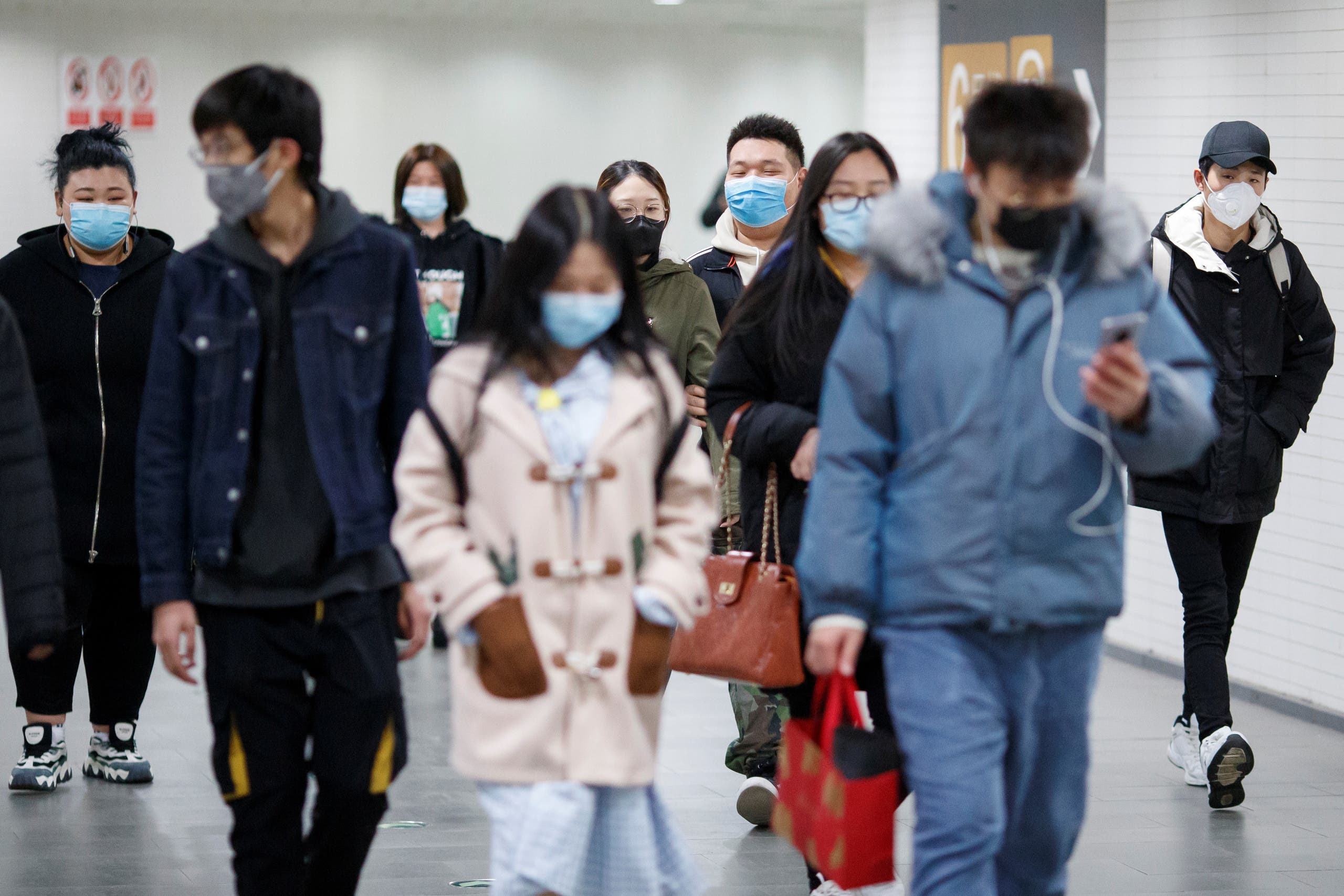People wear protective masks in a subway tunnel during evening rush hour in Beijing as the country is hit by the outbreak of the coronavirus in Beijing, China, March 10, 2020. (Reuters)