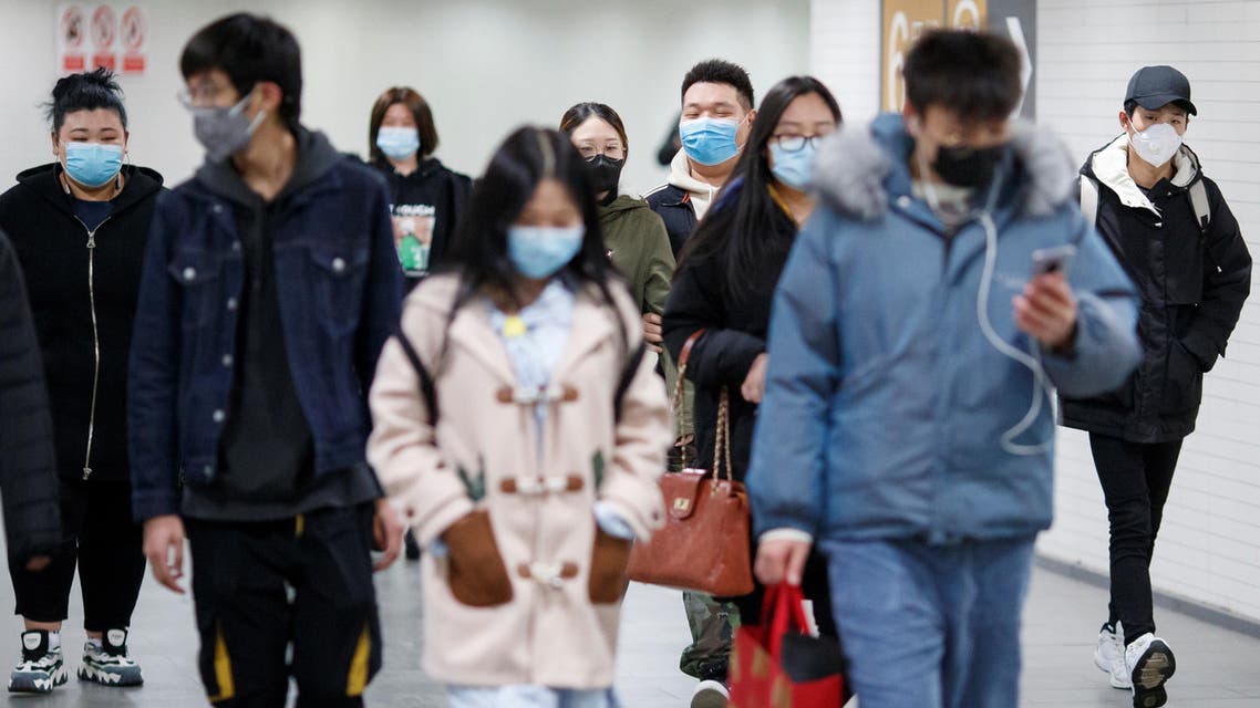 People wear protective masks in a subway tunnel during evening rush hour in Beijing as the country is hit by the outbreak of the coronavirus in Beijing, China, March 10, 2020. (Reuters)