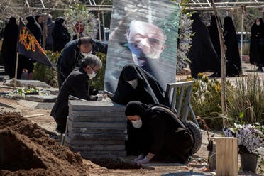 Relatives mourn over the grave of former politburo official in the Revolutionary Guard Farzad Tazari who died after being infected with the coronavirus just outside Tehran on March 10, 2020. (AP)