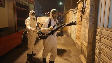 Iranian firefighters disinfect streets and allies in southern Tehran to halt the wild spread of coronavirus on March 11, 2020. (AFP)
