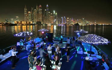 Guests dance during a private party opposite the skyline of the Marina Waterfront in Dubai, United Arab Emirates. (File photo: AP)
