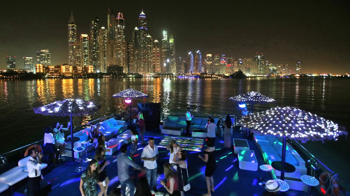 April 22, 2015 photo, guests dance on the GuGu boat during a private party opposite the skyline of the Marina Waterfront in Dubai, United Arab Emirates. (File photo: AP)