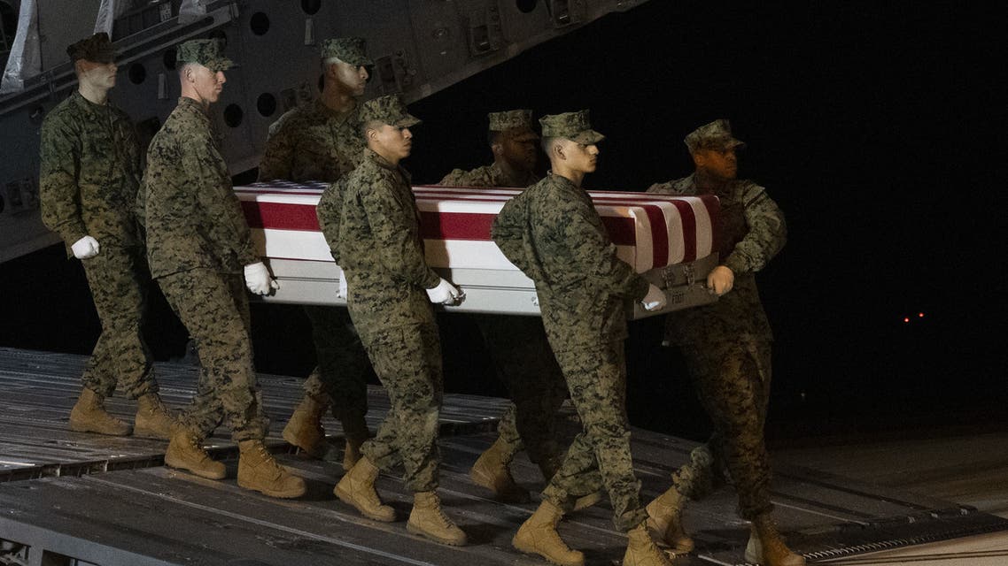 DOVER, DE - MARCH 11: Military personnel carry a transfer case for fallen service member U.S. Marine Gunnery Sgt. Diego D. Pongo, 34, during a dignified transfer at Dover Air Force Base on March 11, 2020 in Dover, Delaware. Pongo and Capt. Moises A. Navas was killed Sunday during a raid on a ISIS complex in Iraq, as part of Operation Inherent Resolve, according to a Department of Defense release. Mark Makela/Getty Images/AFP