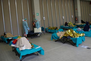 Patients lie on beds at one of the emergency structures that were set up to ease procedures at the Brescia hospital, northern Italy on March 12, 2020. (AP)