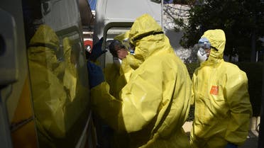Algerian paramedics wearing protective outfits are pictured in front of El-Kettar hospital's special unit to treat cases of novel coronavirus in the capital Algiers on February 26, 2020. (AFP)