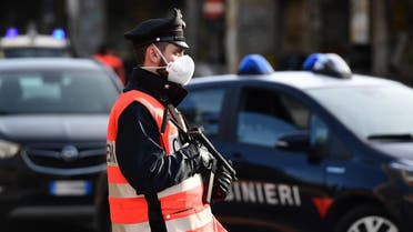 An armed Italian Carabinieri police officer, wearing a respiratory mask as part of precautionary measures against the spread of the new COVID-19 coronavirus in Milan. (File photo: AFP)