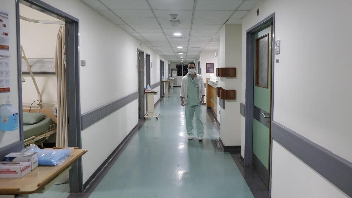 A Lebanese nurse wearing a protective mask walks by at a ward where the first case of coronavirus in the country is being treated, at the Rafik Hariri University Hospital in Beirut, on February 22, 2020. (AFP)