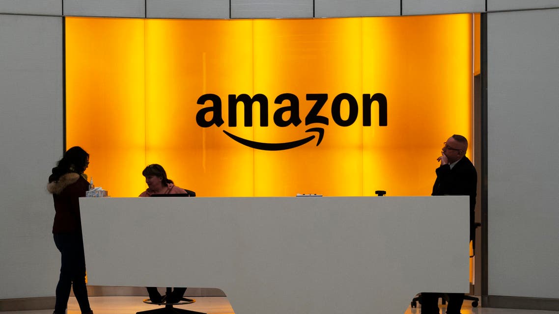 People stand in the lobby for Amazon offices in New York. Amazon says President Donald Trump's ‘improper pressure’ and behind-the-scenes attacks harmed its chances of winning a $10 billion Pentagon contract (File Photo:AP)