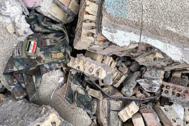 This picture taken on Friday shows a military uniform bearing in the insignia ‘Iraqi Army’ amidst rubble in the aftermath of US military air strikes at a militarized zone in the Jurf al-Sakhr area in Iraq's Babylon province controlled by Kataeb Hezbollah (AFP