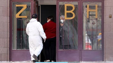 A medical expert in special gear stands at the entrance of Zekai Tahir Burak Hospital where 17 passengers of a Turkish Airlines flight from Tehran, suspected of having coronavirus, were to be quarantined, in Ankara. (Reuters)