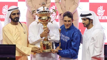 Trainer Saeed bin Suroor and jockey Christophe Soumillon pose with the trophy after winning the Dubai World Cup Sponsored By Emirates Airline on Thunder Snow alongside Dubai's Ruler Sheikh Mohammed bin Rashid al-Maktoum, Prime Minister and Vice-President of the United Arab Emirates REUTERS